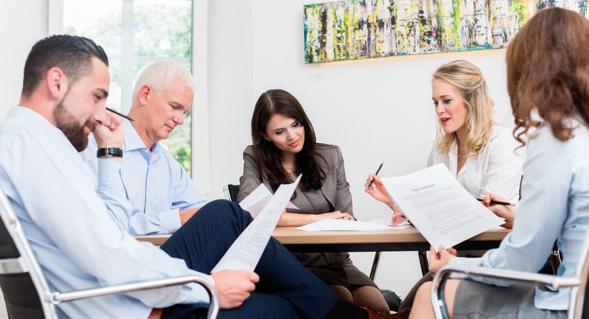 45826292 - lawyers having team meeting in law firm reading documents